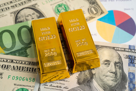 Gold bars with US dollar and Euro banknote money, finance trading investment business currency.の写真素材