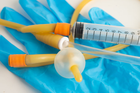Foley catheter and urine drainage bag collect urine for patient in hospital.の写真素材