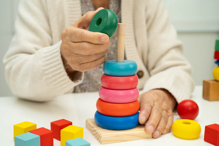 Asian elderly woman playing enhancing skill board game.の写真素材