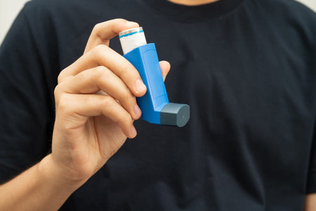 Asthma and chronic obstructive pulmonary disease COPD, Asian teenage using metered dose inhaler MDI.