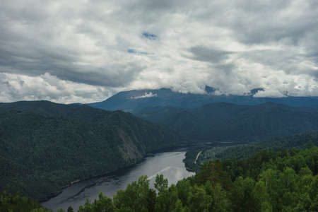 River flowing in the midst of wooded mountainsの写真素材