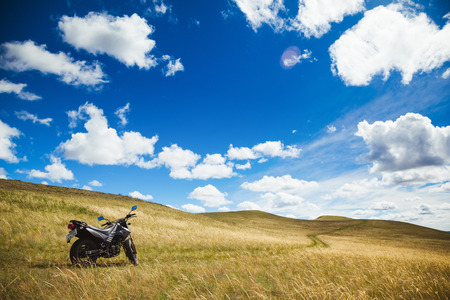 motorcycle on a field on a sunny dayの写真素材