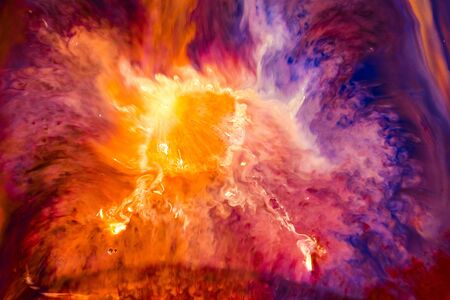 Watercolor paints of different colors are poured into a white containerの写真素材