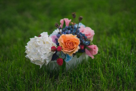 A small pot of artificial flowers made of cold clayの写真素材