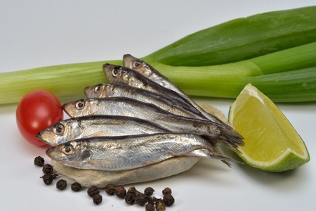 Salted Sprat Fish With Black Pepper, Leek,Lime Slice and Tomato, isolated on white backgroundの写真素材