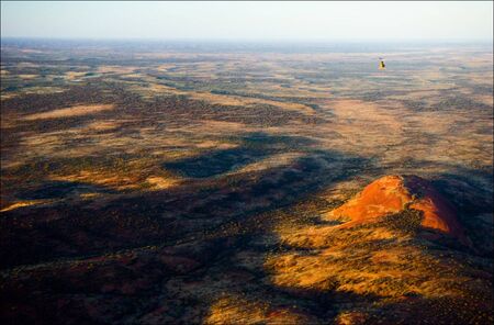 The highest monolith, Mount Olga in brightly red color of the coming sun.の写真素材