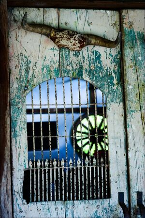 Old door. An old, shabby door in the thrown house.の写真素材