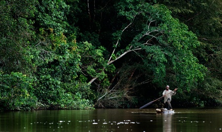 SANGHA RIVER, CENTRAL AFRICA, JUNGLE BETWEEN CAMEROON AND CENTRAL AFRICAN REPUBLIC, 01 NOVEMBER 2008: The local resident floats in the hollowed wooden boat down the river. The Sangha River, a river in central Africa, is a tributary of the Congo River. Novのeditorial素材