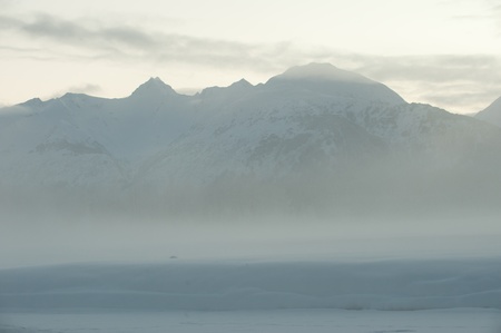 The Chilkat Valley under a covering of snow, with mountains behind. Southeast Alaska.の写真素材