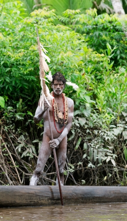 INDONESIA, IRIAN JAYA, ASMAT PROVINCE, JOW VILLAGE - JUNY 28: The Portrait Asmat warrior with a traditional painting and coloring on a face. June 28, 2012 in Jow Village, Asmat province, Indonesiaのeditorial素材