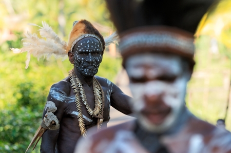 INDONESIA, IRIAN JAYA, ASMAT PROVINCE, JOW VILLAGE - JUNY 28: The Portrait Asmat warrior with a traditional painting and coloring on a face. June 28, 2012 in Jow Village, Asmat province, Indonesiaのeditorial素材