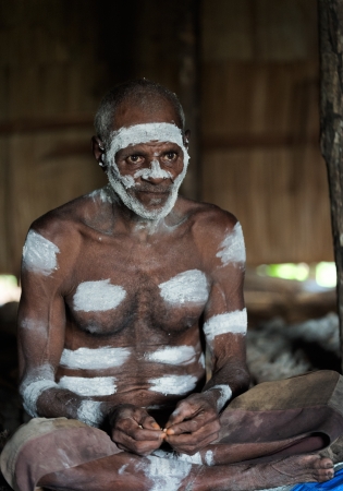 INDONESIA, IRIAN JAYA, ASMAT PROVINCE, JOW VILLAGE - JUNY 28: The Portrait Asmat warrior with a traditional painting and coloring on a face. June 28, 2012 in Jow Village, Asmat province, Indonesiaのeditorial素材