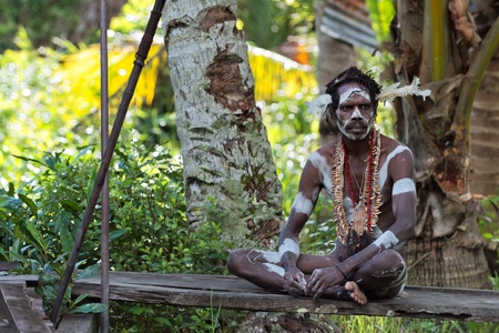 INDONESIA, IRIAN JAYA, ASMAT PROVINCE, JOW VILLAGE - JUNY 28: The Portrait Asmat warrior with a traditional painting and coloring on a face. June 28, 2012 in Jow Village, Asmat province, Indonesiaのeditorial素材