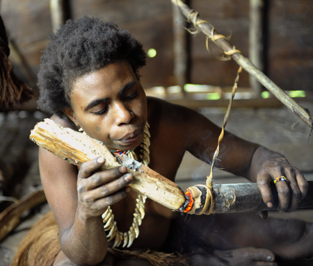 The Portrait of  the getting a light Koroway woman in the house on the tree.のeditorial素材