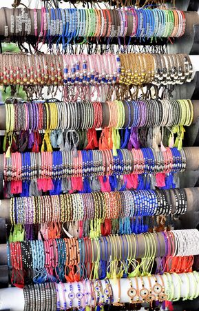 Colorful bracelets on display case in street jewelry store