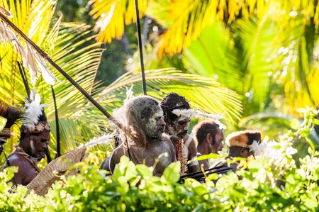 JOW VILLAGE, ASMAT, NEW GUINEA, INDONESIA -JUNE 28,2012: Asmat in a traditional coloring and dresses in the wood . Doroe ceremony. June28, 2012. Jow Village, Asmat, Indonesiaのeditorial素材