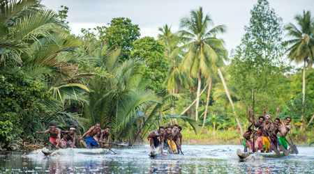 INDONESIA, IRIAN JAYA, ASMAT PROVINCE, JOW VILLAGE - JUNE 23: Canoe war ceremony of Asmat people. Headhunters of a tribe of Asmat . New Guinea Island, Indonesia. June 23, 2016のeditorial素材