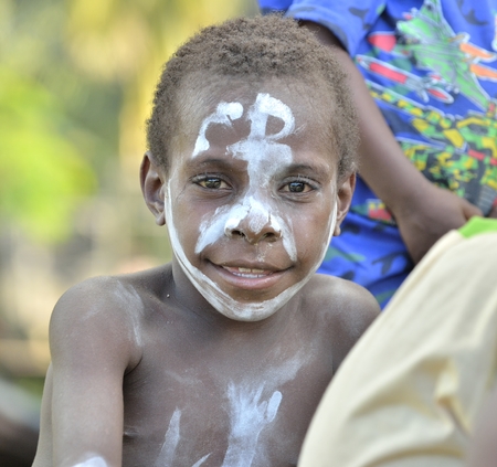 WEST PAPUA (IRIAN JAYA), ASMAT PROVINCE, NEW GUINEA, INDONESIA - MAY 22, 2016: - Unidentified boy of an asmat tribe in a small forest traditional village in jungle of New Guinea. May 22, 2016のeditorial素材