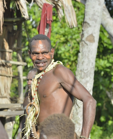 YOUW VILLAGE, ATSY DISTRICT, ASMAT, NEW GUINEA, INDONESIA - MAY 23: Head hunter of a tribe of Asmat. Traditional facepainting and headdress. May 23, 2013, Youw Village, Irian Jaya province, Indonesiaのeditorial素材