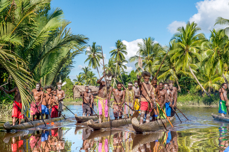 INDONESIA, IRIAN JAYA, ASMAT PROVINCE, JOW VILLAGE - JUNE 13: Canoe arriving during canoe war feast. Canoe war ceremony of Asmat people. Headhunters of a tribe of Asmat . New Guinea Island, Indonesia. June 13, 2016のeditorial素材