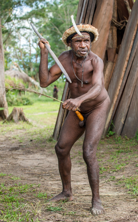 DANI VILLAGE, WAMENA, IRIAN JAYA, NEW GUINEA, INDONESIA - JUNE 4: The  armed Papuan Warrior of Dani Dugum tribe with spear. June 4, 2016, New Guinea Island.のeditorial素材