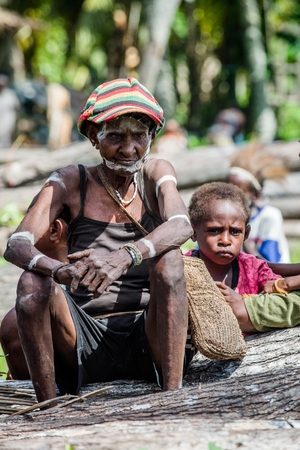 YOUW VILLAGE, ATSY DISTRICT, ASMAT, NEW GUINEA, INDONESIA - MAY 23: Portrait of Papuan women from Asmat tribe in small village on the deep jungle of New Guinea. Irian Jaya. Indonesia. May 23, 2016のeditorial素材