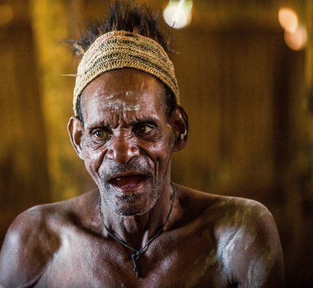 YOUW VILLAGE, ATSY DISTRICT, ASMAT REGION, IRIAN JAYA, NEW GUINEA, INDONESIA - MAY 23, 2016: Portrait of a man from the tribe of Asmat people with ritual face painting on Asmat Welcoming ceremonyのeditorial素材