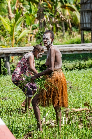 YOUW VILLAGE, ATSY DISTRICT, ASMAT, NEW GUINEA, INDONESIA - MAY 23: Portrait of Papuan women from Asmat tribe in small village on the deep jungle of New Guinea. Irian Jaya. Indonesia. May 23, 2016のeditorial素材