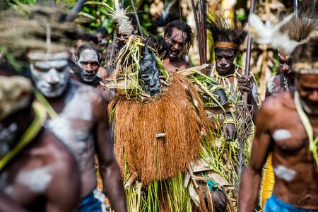YOUW VILLAGE, ATSY DISTRICT, ASMAT, NEW GUINEA, INDONESIA - MAY 23: The Village follows the ancestors embodied in spirit mask as they tour the village. Jjungle of New Guinea.Indonesia. May 23, 2016のeditorial素材