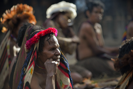 BALIEM VALLEY, WEST PAPUA, INDONESIA, JUNE 16th, 2016: Close up Portrait of adult woman in the traditional headdress of bird feathers. Dugum Dani tribe people.  New Guinea, Indonesia,June 16, 2016のeditorial素材