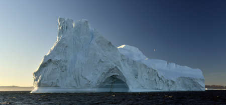 Iceberg floating in the water off the coast of Greenland. Nature and landscapes of Greenland.