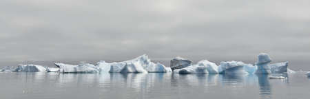 Iceberg floating in the water off the coast of Greenland. Nature and landscapes of Greenland.