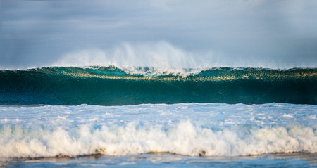 Powerful ocean wave on the surface of the ocean. Wave breaks on a shallow bank. Stormy weather,...
