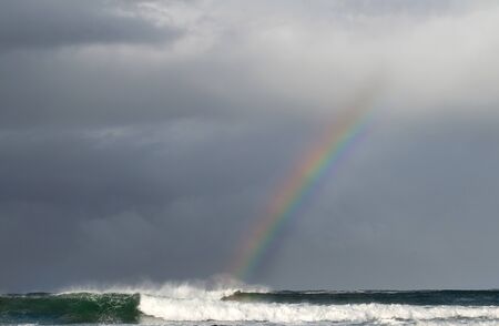 Thunderclouds and rainbow over the ocean. South Africa.の写真素材