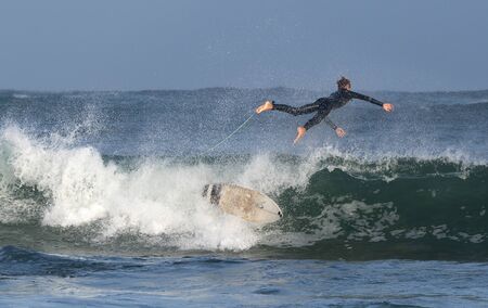 Mossel Bay, South Africa. Surfing the waves. Surfer riding wave,  storm skyの写真素材