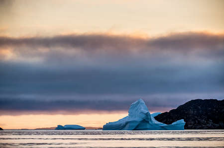 Iceberg at sunset in the Disco Bay, Greenland. Their source is by the Jakobshavn glacier.の写真素材