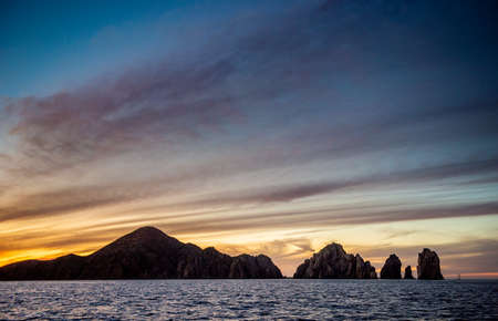 Beautiful Sunset of Seascape with Mountains silhouettes. Sea off the Coast of Cabo San Lucas. Gulf of California (also known as the Sea of Cortez, Sea of Cortes. Mexico. Sunset over Cabo San Lucasの写真素材