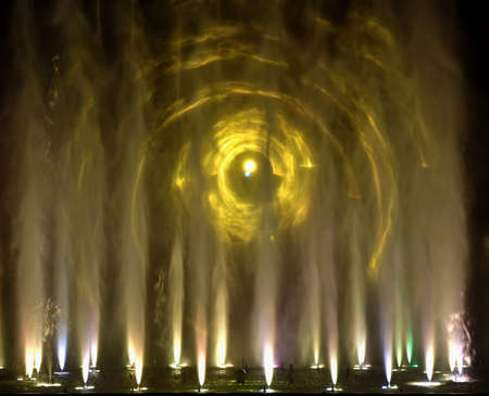 colorful water fountains. Beautiful laser and fountains show. Large multi colored decorative dancing water jet led light fountain show at night. dark background.の素材 [FY310182114113]