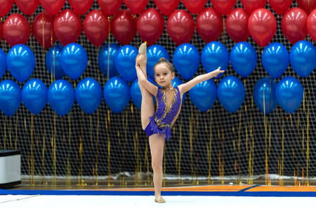 Saint Petersburg, Russia - February 2, 2020: Children's Rhythmic Gymnastics Competition "Rising Stars". Adorable sporty little girl in rhythmic gymnastics.のeditorial素材