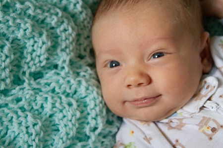 Close up of baby s happy face with smiling eyes 