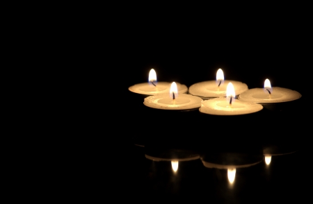 Small candles in darkの写真素材