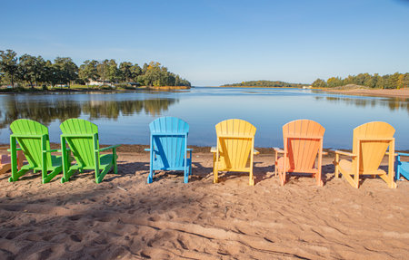 Colourful deck chairs on autumn beachの写真素材
