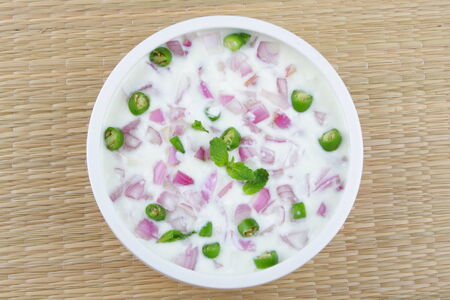 Indian curry accompaniment cucumber raita, made from yoghurt, cucumber, green chili, roasted ground...