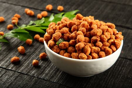 Tasty appetizer coated nuts in bowl.