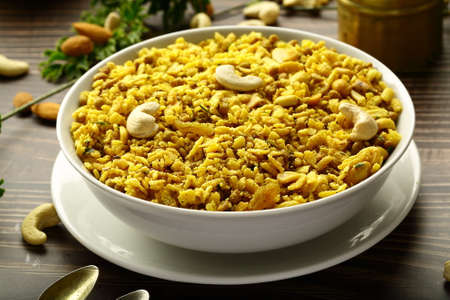 Pilaf in a bowl on wooden background. Traditional Indian dish.