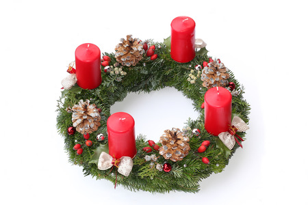 advent wreath with red candles, natural decoration made of cones, ilex and rose hip, silver glittering and beautiful ribbonの写真素材