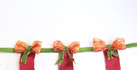 green gift wrap with  decorated ribbons, isolated on whiteの写真素材