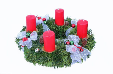 Advent wreath with four red candles and silver ribbon, handicraft workの写真素材