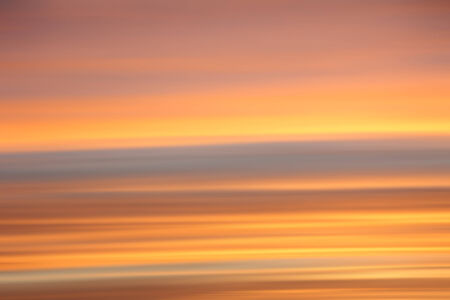 soft sunset sky background, striped in shades of orange and greyの写真素材