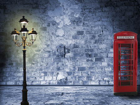 Vintage scenery, brick wall, lantern and phone box, night scenery in the streetの写真素材
